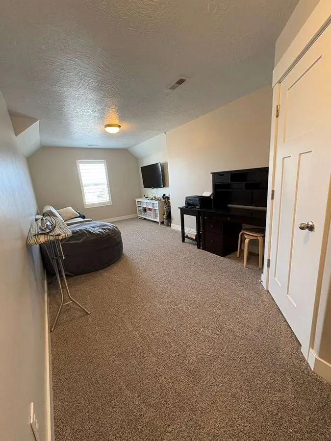 After cleaning — tidy, organized bonus room with clean carpet in Salt Lake City Utah home, cleaned by Maid For You Utah