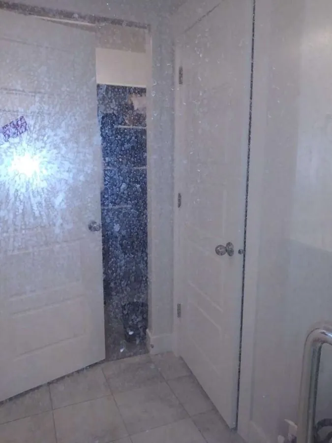 Before cleaning — heavily fogged shower glass with hard water mineral deposits in Park City Utah vacation rental