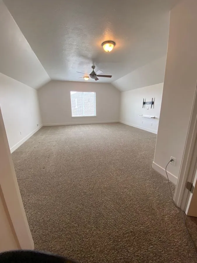 After cleaning — spotless empty bedroom with clean carpet in Bluffdale Utah, ready for move-in